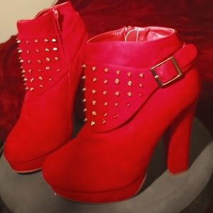 Red suede heeled boots with gold studs